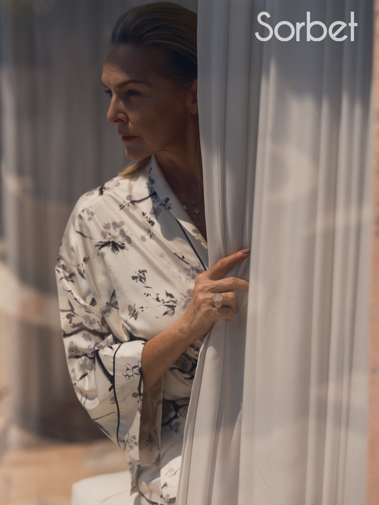 woman looking through a window in Milan wearing Dior jewelry and Dior clothes