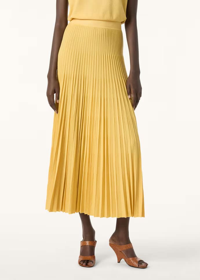 Female model wearing Tartana Skirt by Loro Piana in yellow