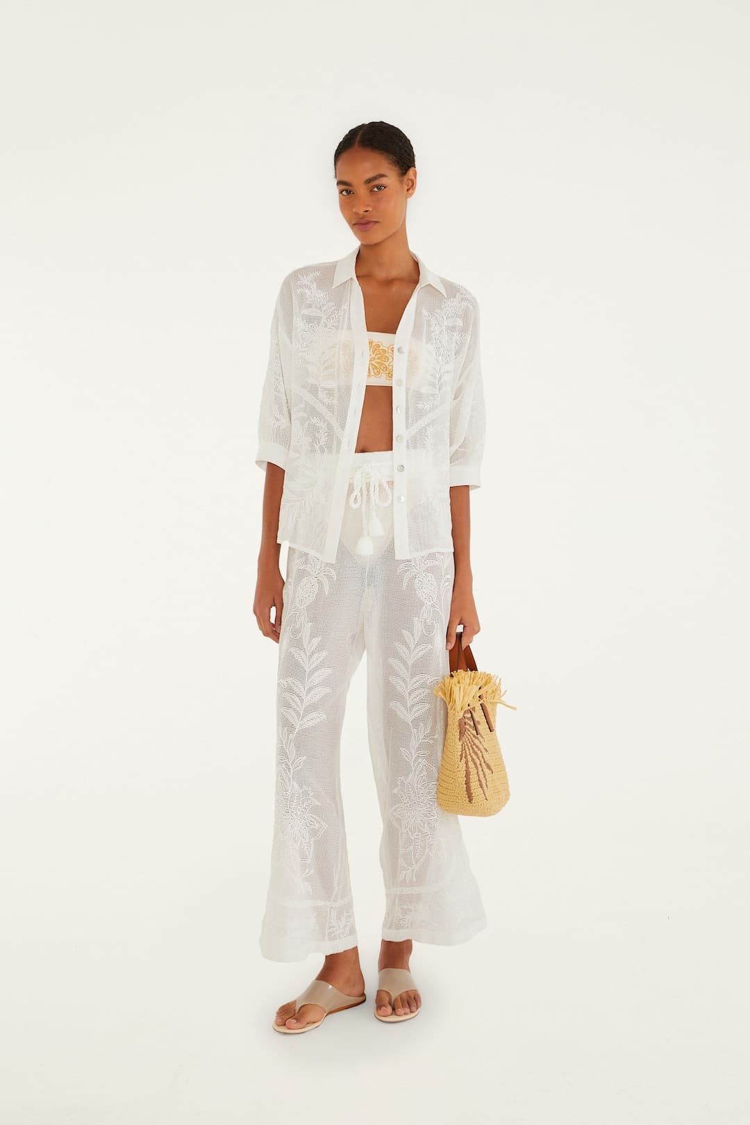 Female model wearing Off-White Nina Blouse and Pants by Farm Rio holding a yellow straw bag