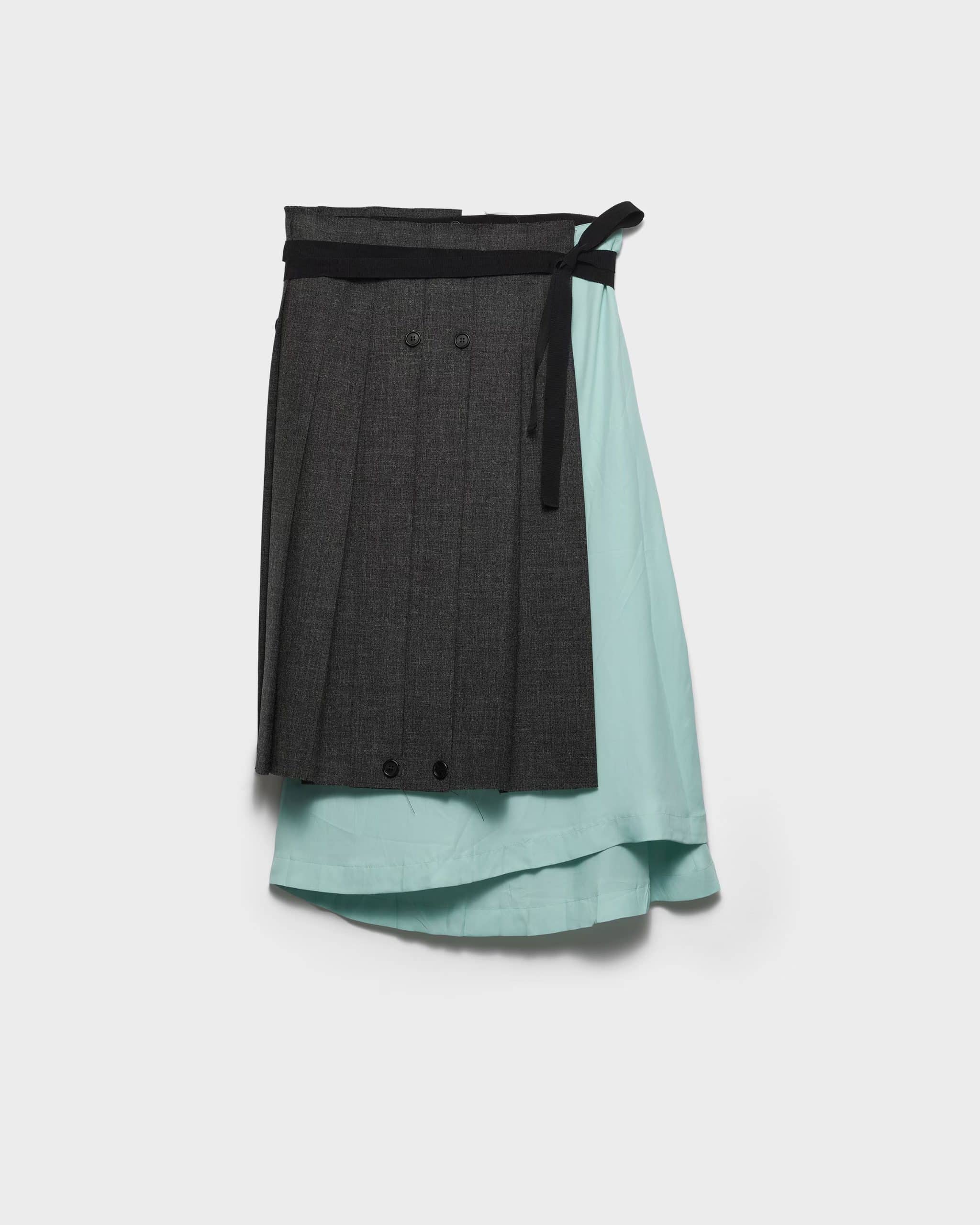 Prada two-tone Patchwork Skirt in grey on the left side and light blue on the right side presented on a white background