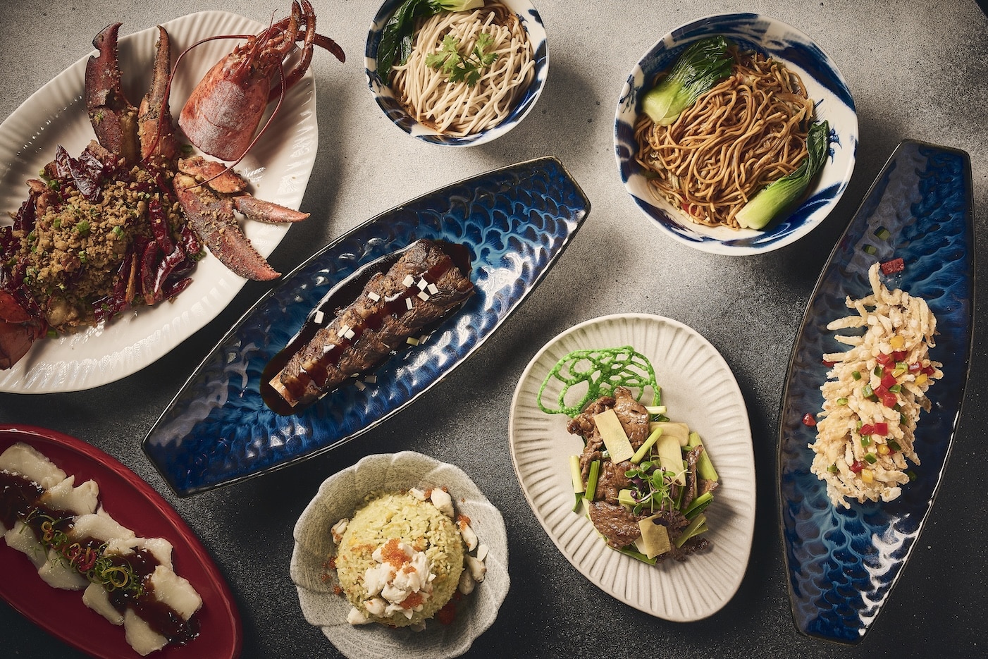 A spread of gourmet Chinese dishes from the Naughty Noodle Brunch at Maiden Shanghai, FIVE Palm Jumeirah, featuring lobster, noodles, and dim sum for the Sorbet Easter Guide.
