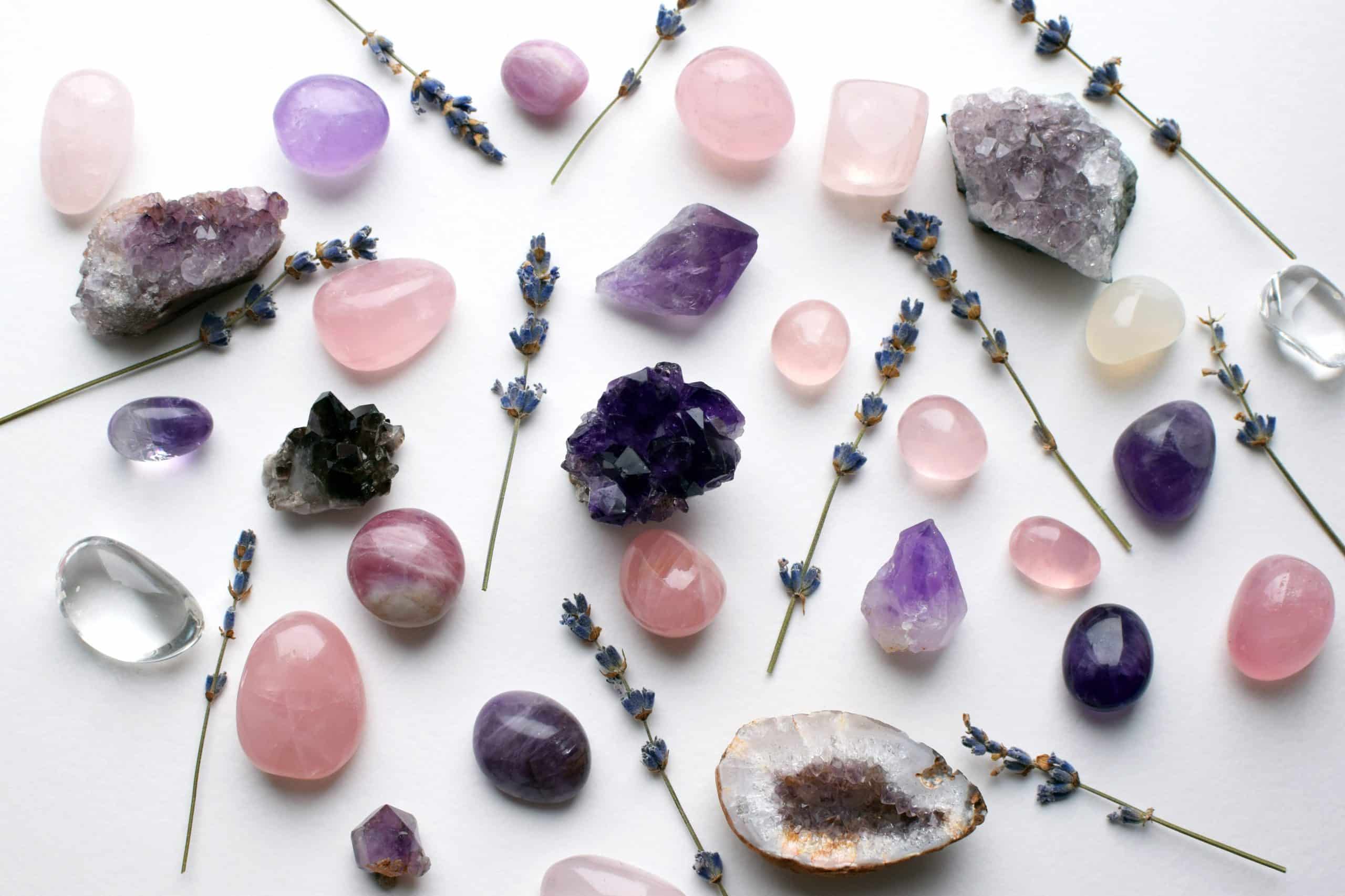 Natural crystals amethyst druse and rose quartz minerals on a background with lavender sprigs. Healing crystals.