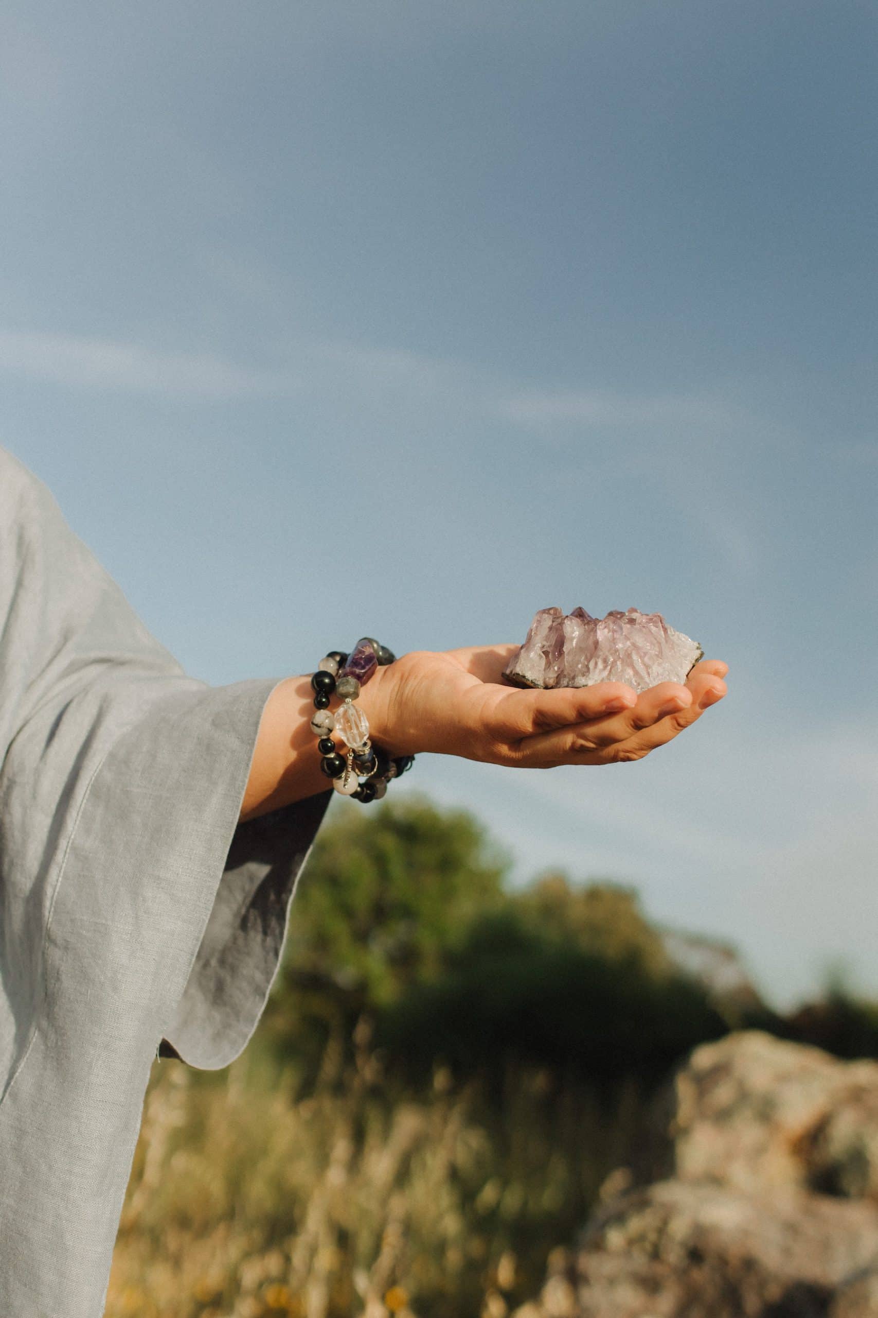 Close-up of female hands holding natural healing stones. Tools for energy balance, emotional support, self-discovery through intention, intuition, gentle presence. Vintage tone. Soft focus, blurred.