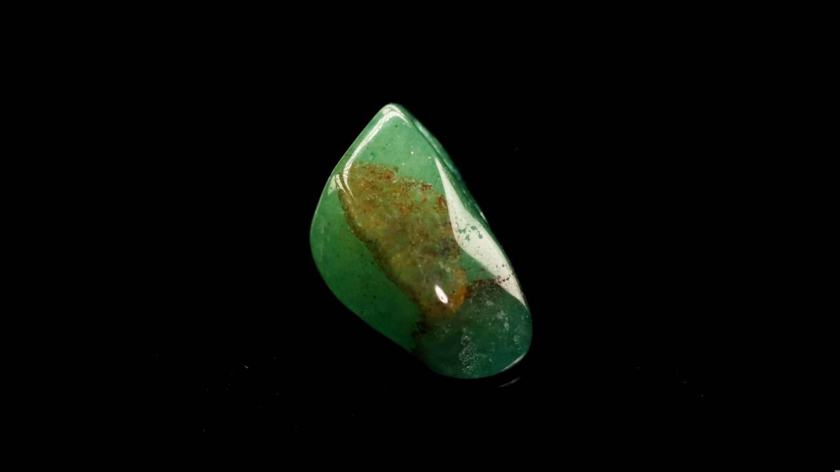 A,Smooth,,Glossy,Green,Aventurine,Stone,Featuring,Natural,Inclusions,Against